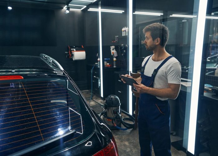 worker-of-car-service-entering-information-about-detailing-to-tablet.jpg